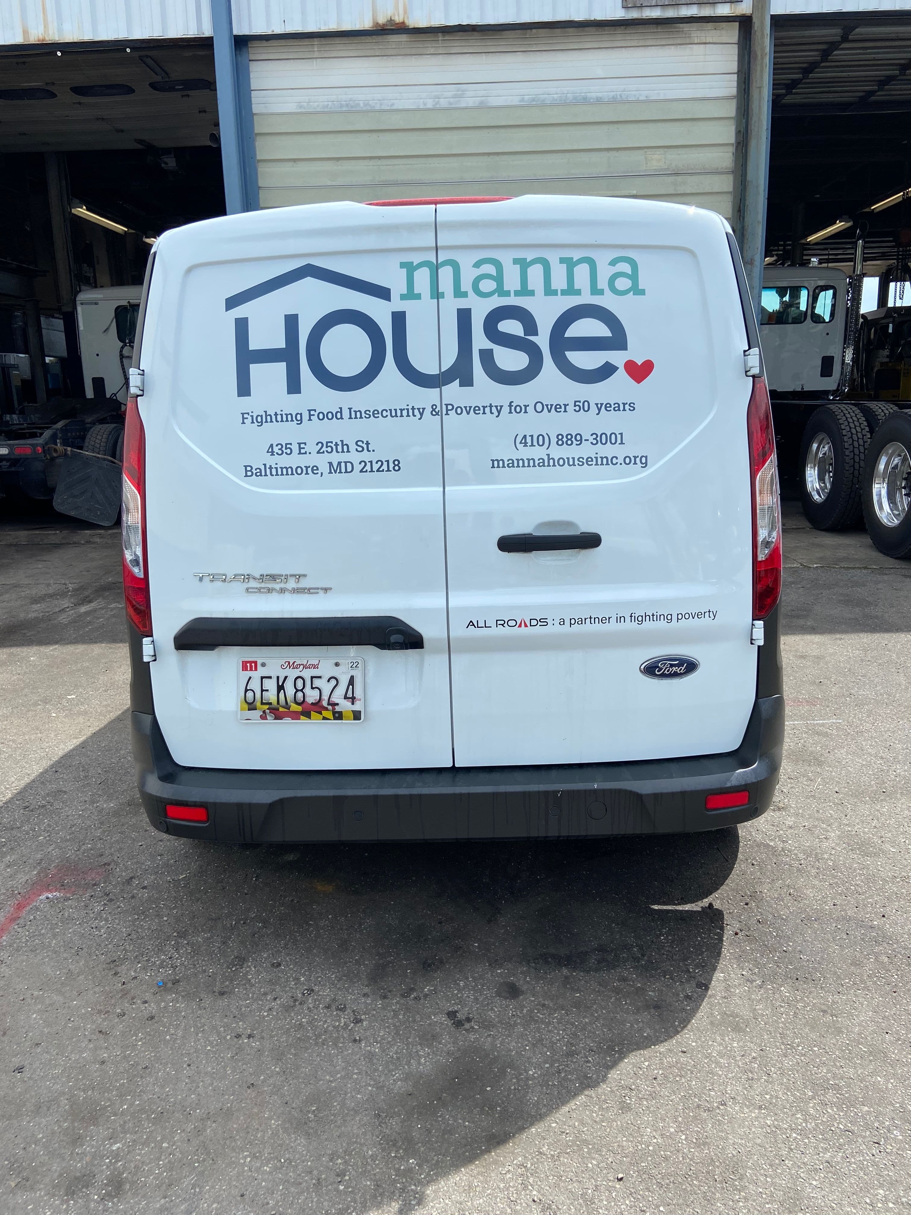 Manna House Decal on the Back of a Van